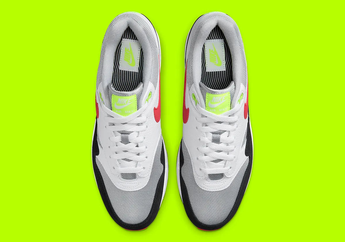 Nike Air Max 1 Chili Volt, sneaker Nike Air Max 1 avec coloris Chili et Volt, amorti Nike Air visible et finitions premium.