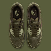 Sneakers Nike Air Max 90 Premium Skunk vert foncé en matières premium texturées avec unité Air visible et design iconique