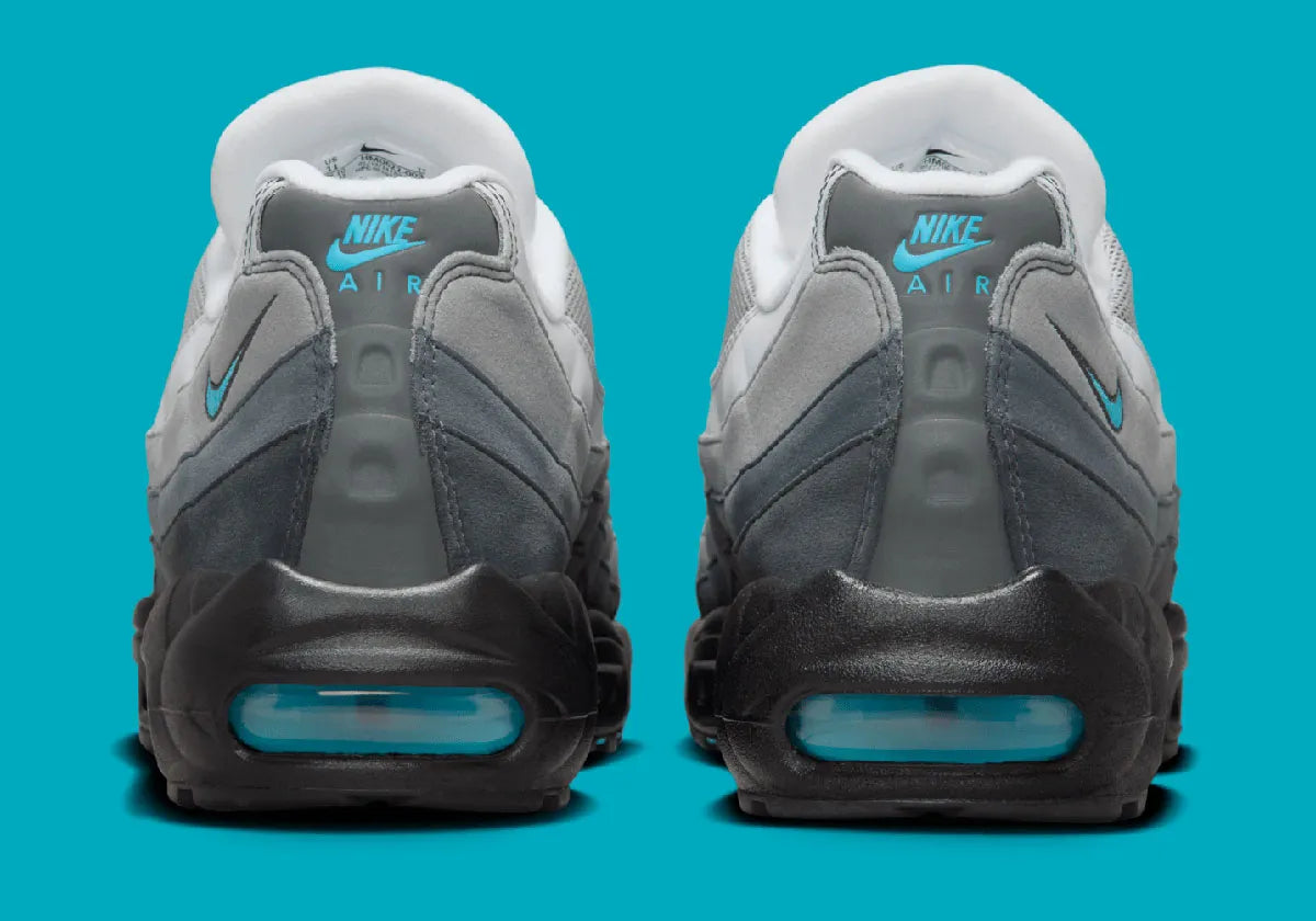 Nike Air Max 95 Baltic Blue, sneaker grise Iron Grey et Smoke Grey avec détails bleu Baltic et unités Nike Air visibles.