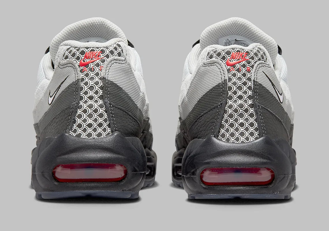Nike Air Max 95 Fish Scales grise, noire et blanche avec motif écailles au talon, empiècements texturés et unités Air visibles.