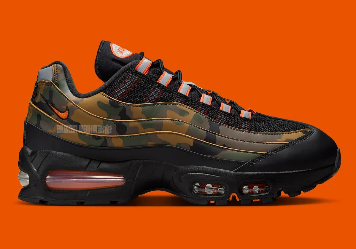 Sneakers Nike Air Max 95 Safety Orange Camo en matériaux premium avec motif camouflage, accents orange et unités Air visibles vue de profil. 