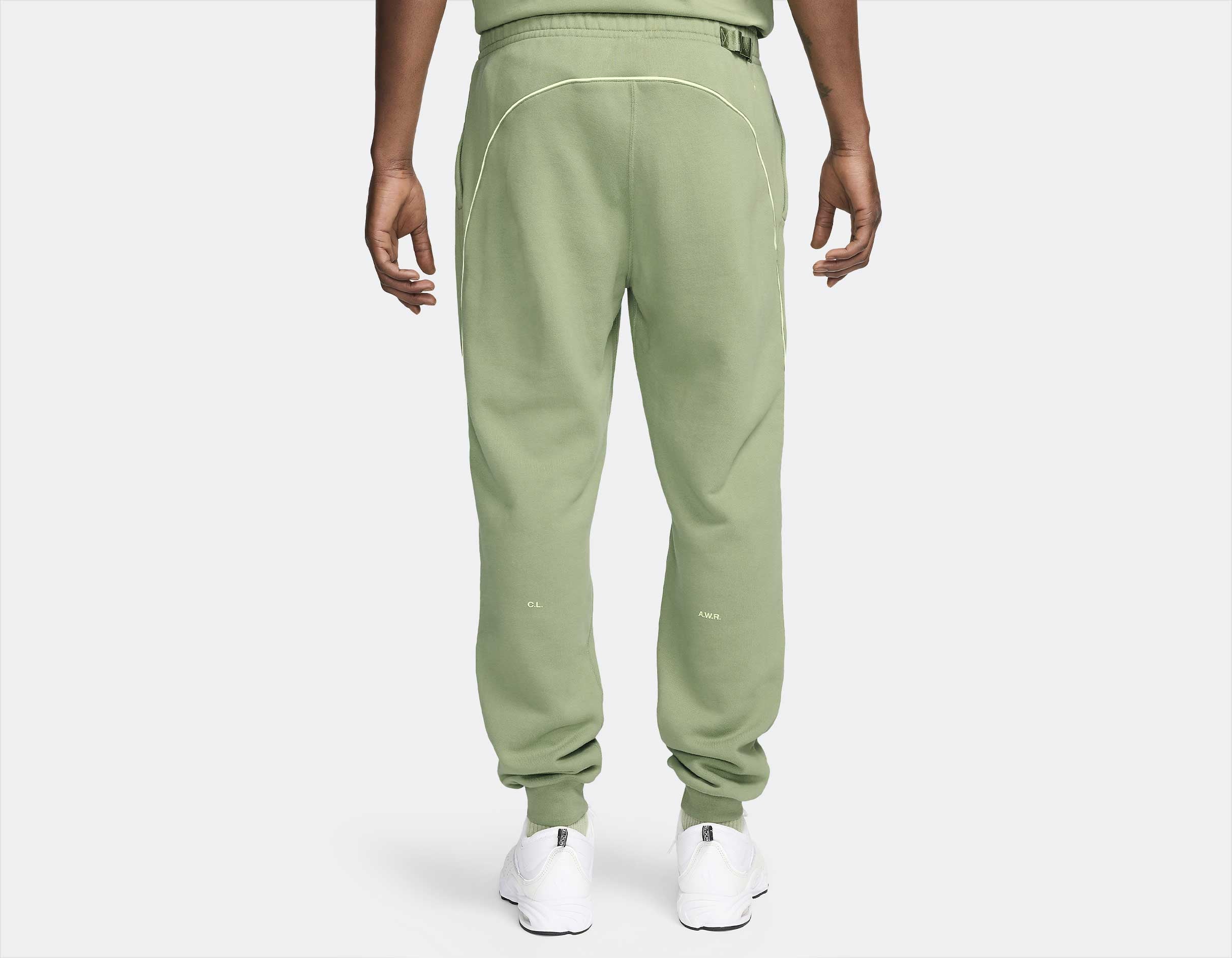 Light Liquid Lime, pantalon fleece vert avec coupe ample, poches zippées et détails réfléchissants NOCTA.