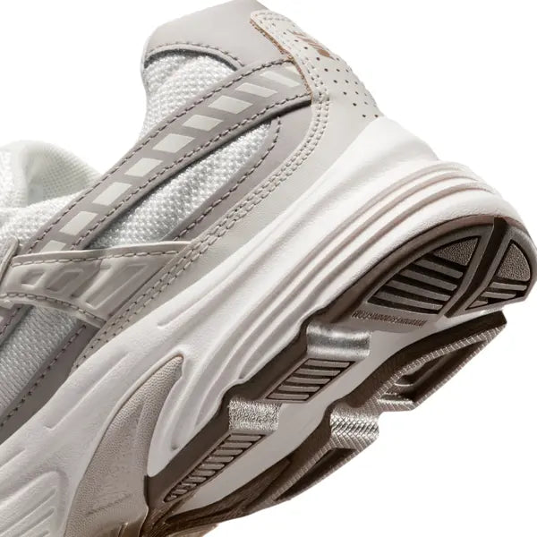 Vue zoomée sur les détails arrières de la Nike Initiator Phantom Light Bone Sail Mink Brown IB4339-001 avec tige crème et beige, détails bruns et silhouette rétro-running multicouche.