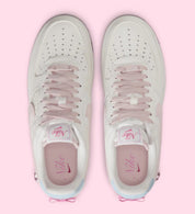 Sneakers Nike Air Force 1 Low Valentine's Day 2026 pour femme en cuir premium clair, avec détails roses et rouges, motifs exclusifs et amorti Nike Air encapsulé.Vue de haut