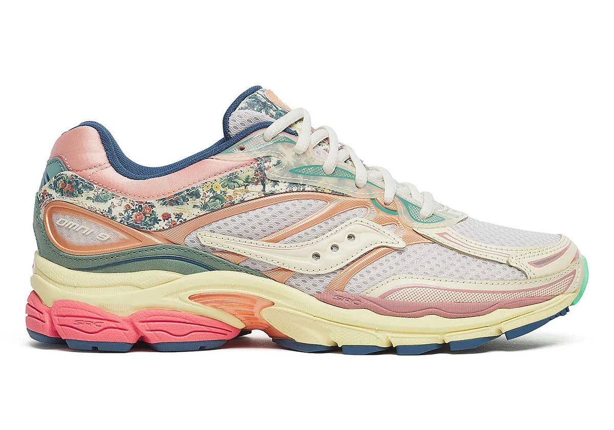 Sneaker Saucony ProGrid Omni 9 beige avec détails bleus floraux en mesh respirant et semelle amortissante ProGrid