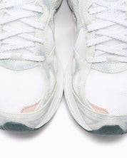 Saucony ProGrid Guide 7 Spiritual Guidance White Verde avec tige en mesh blanc, empiècements verts et cuir, technologie ProGrid et semelle extérieure en caoutchouc.
